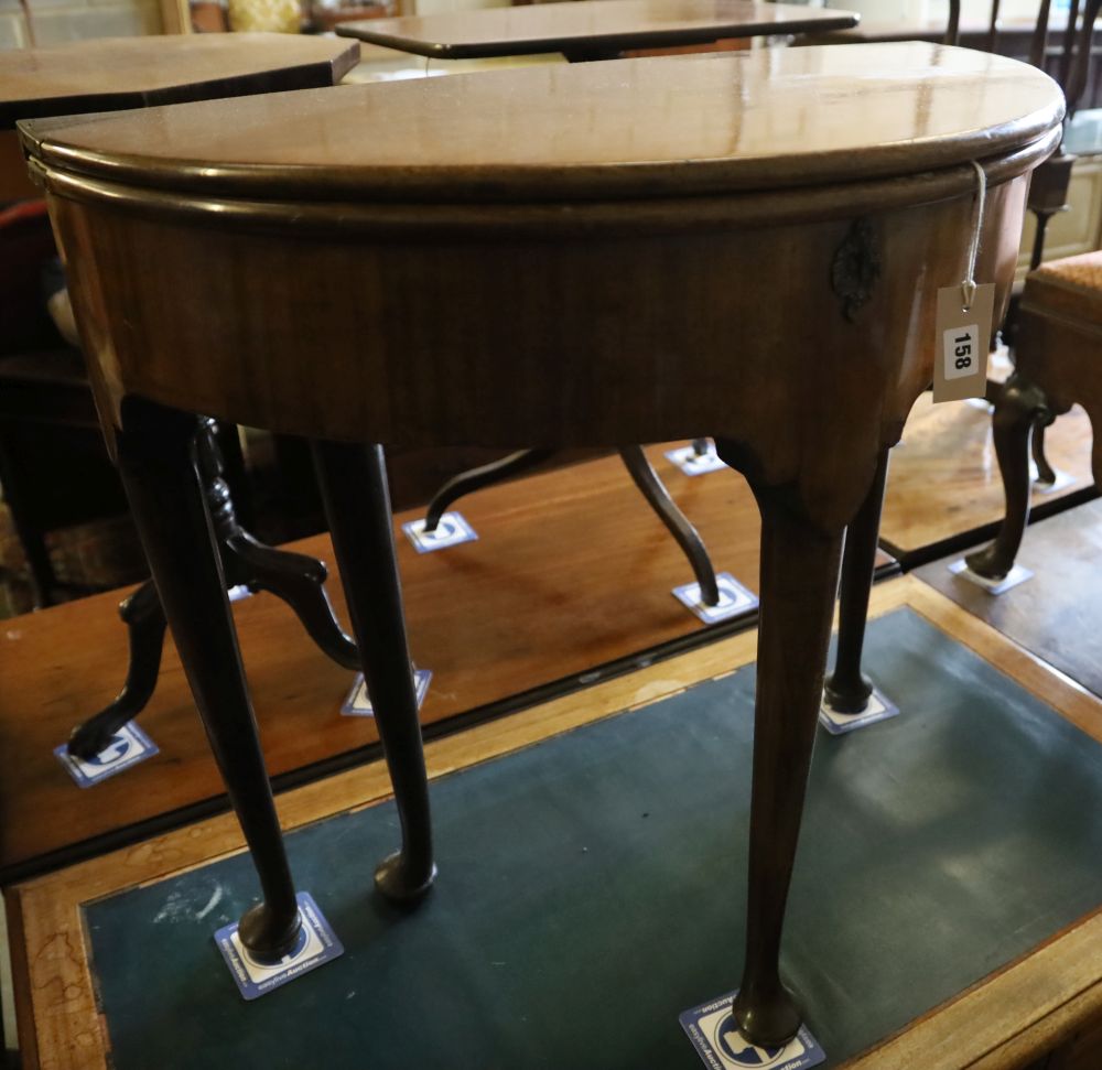 A George II mahogany and fruitwood games table, with hinged top and raised on pole and pad supports, width 75cm, depth 38cm, height 73c